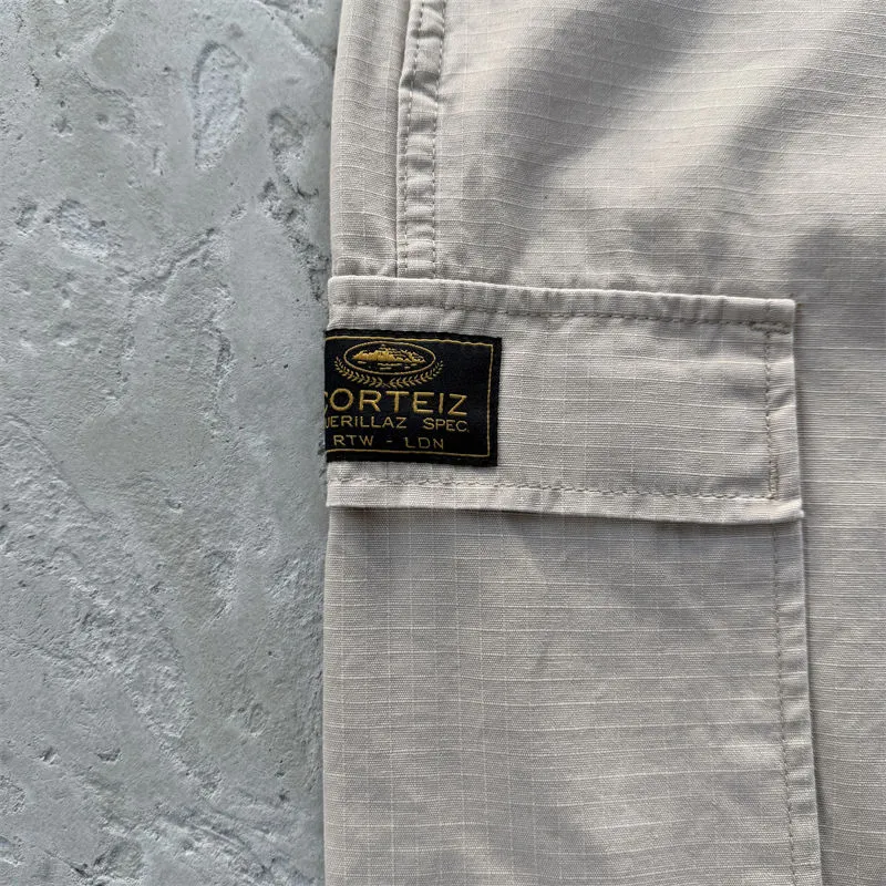 Corteiz Guerillaz Cargo Pants pocket detail in a neutral colour