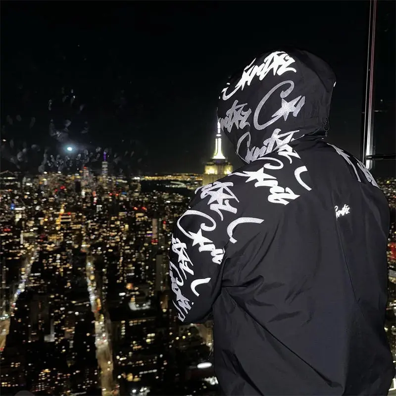 Corteiz Elitework Waterproof Shell Jacket V2 worn from the back in a city setting