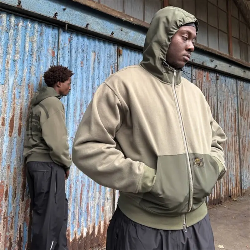 Olive Corteiz Guerillaz Ripstop Zip Hoodie worn as a transitional streetwear layer
