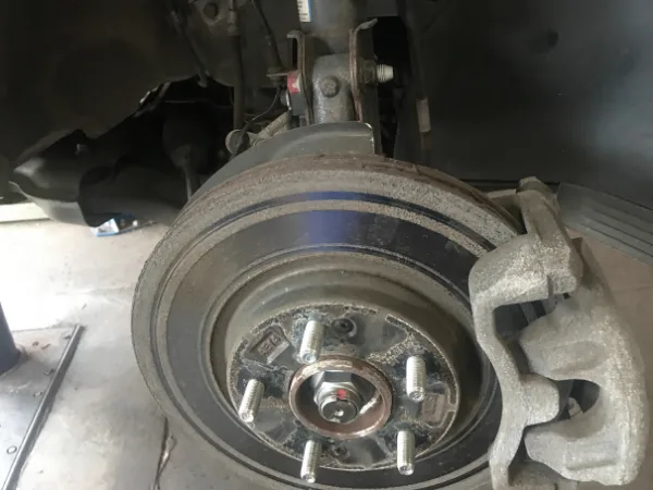 Inspecting rusted brake rotor to decide resurfacing or replacement