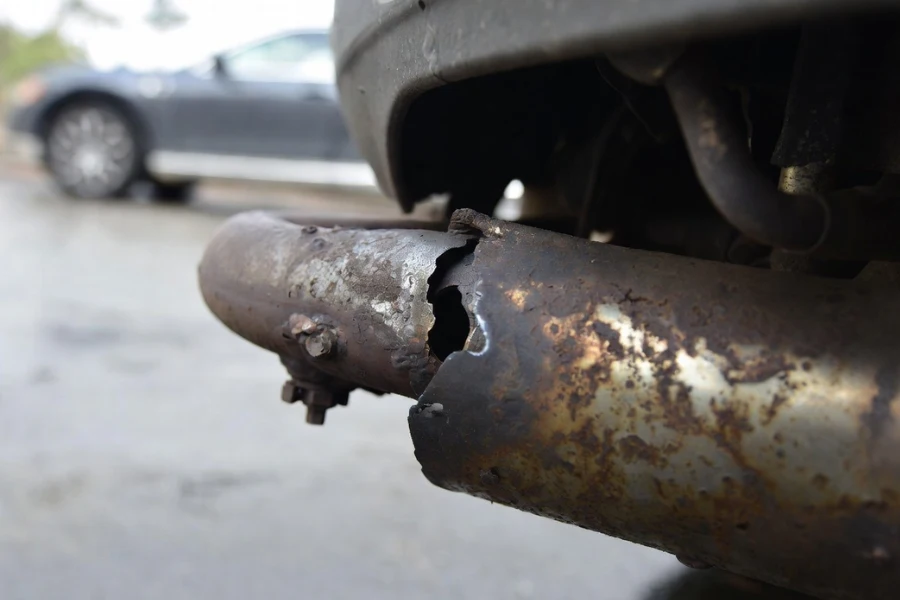 rusted broken silencer showing exhaust leak symptoms
