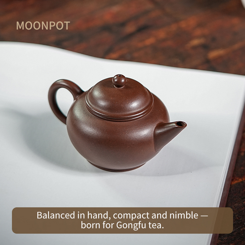 Yixing Purple Clay Moonpots — Shuiping (Level) Teapot. Crafted from raw Zi Sha purple clay, designed as a Gongfu tea brewing vessel. 130ml capacity.