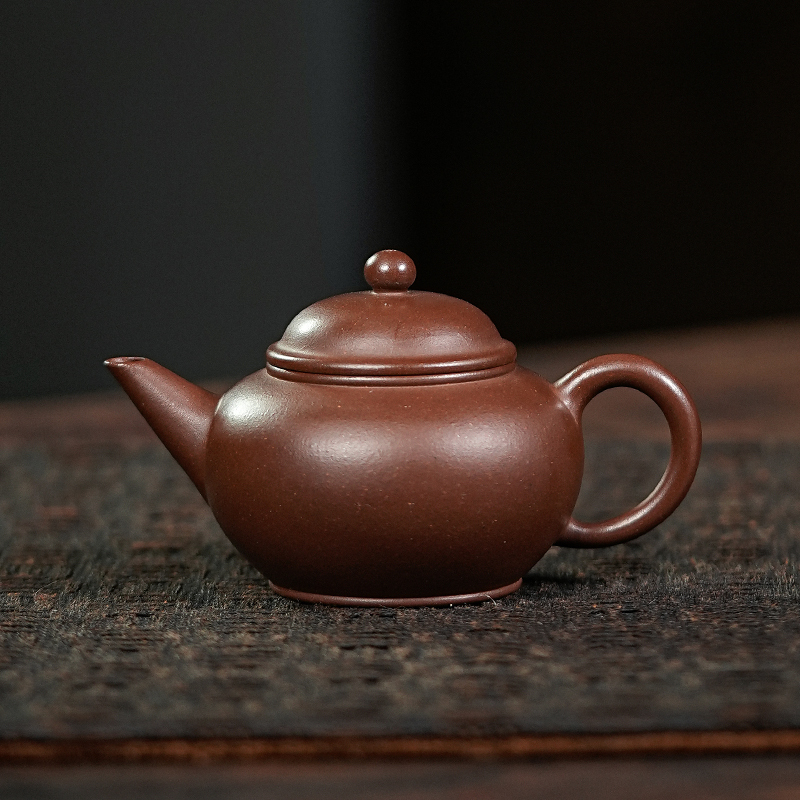Yixing Purple Clay Moonpots — Shuiping (Level) Teapot. Crafted from raw Zi Sha purple clay, designed as a Gongfu tea brewing vessel. 130ml capacity.