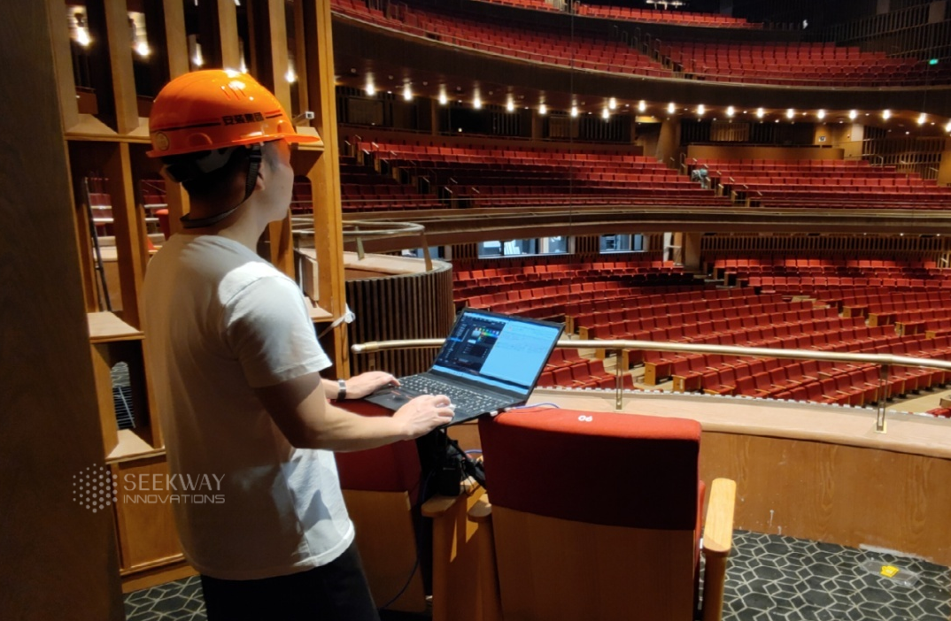 Seekway technician tests venue lighting system on laptop