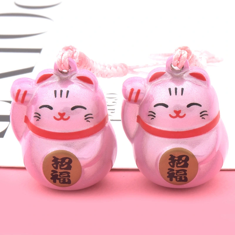 The Maneki-neko Water Sound Bell Omamori for Good Luck and Wealth Attraction from Sensoji Temple in Japan. (Here, "Maneki-neko" is the Japanese name for the beckoning cat, which is often associated with attracting good fortune and wealth in Japanese cultu