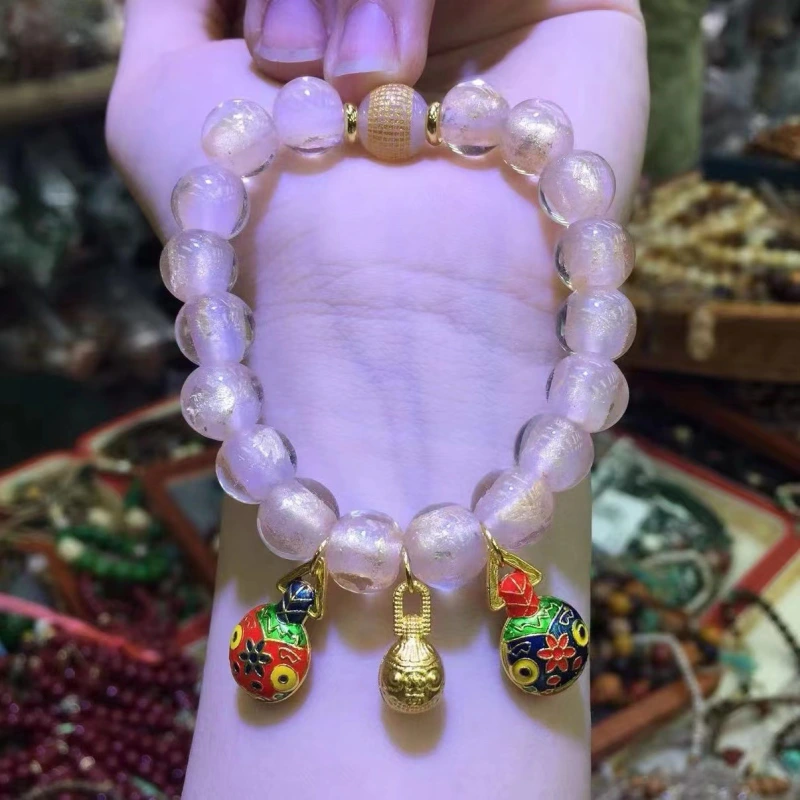 This purple glass bead bracelet comes from Chinese temples. It is believed to bring good luck, love and empower the wearer.
