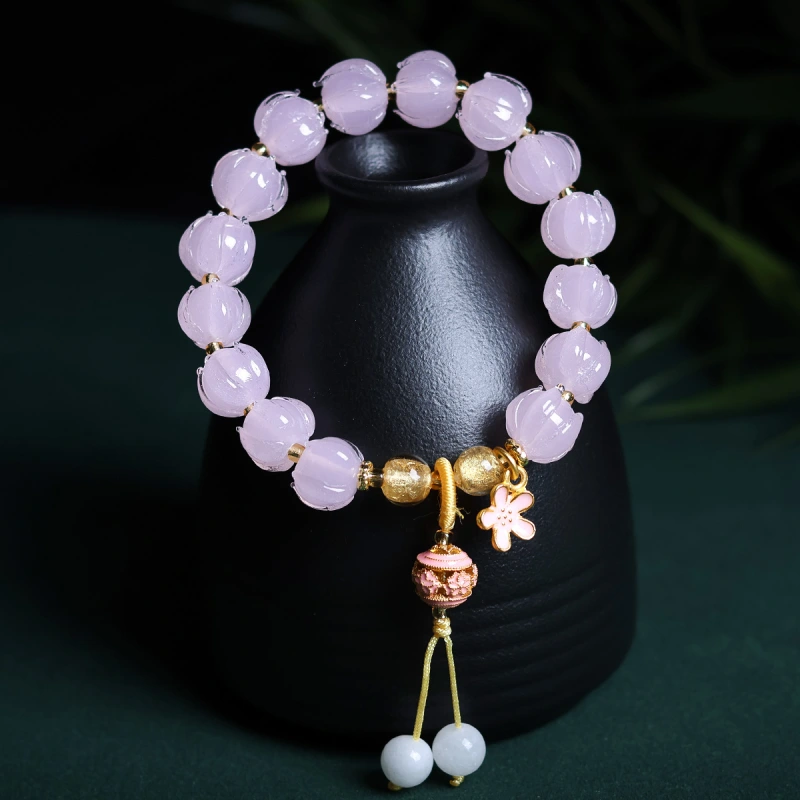 This purple glass bead bracelet comes from Chinese temples. It is believed to bring good luck, love and empower the wearer.