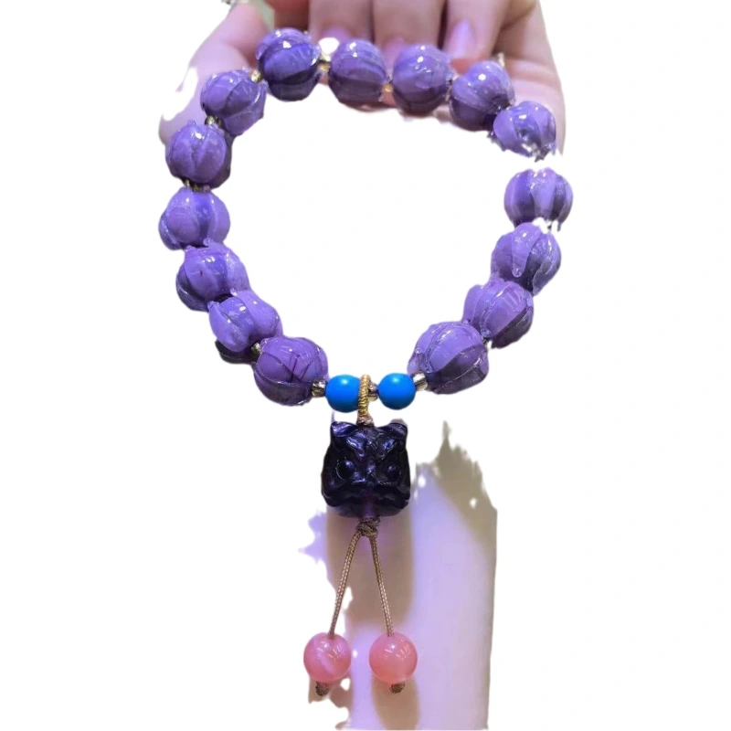 This purple glass bead bracelet comes from Chinese temples. It is believed to bring good luck, love and empower the wearer.
