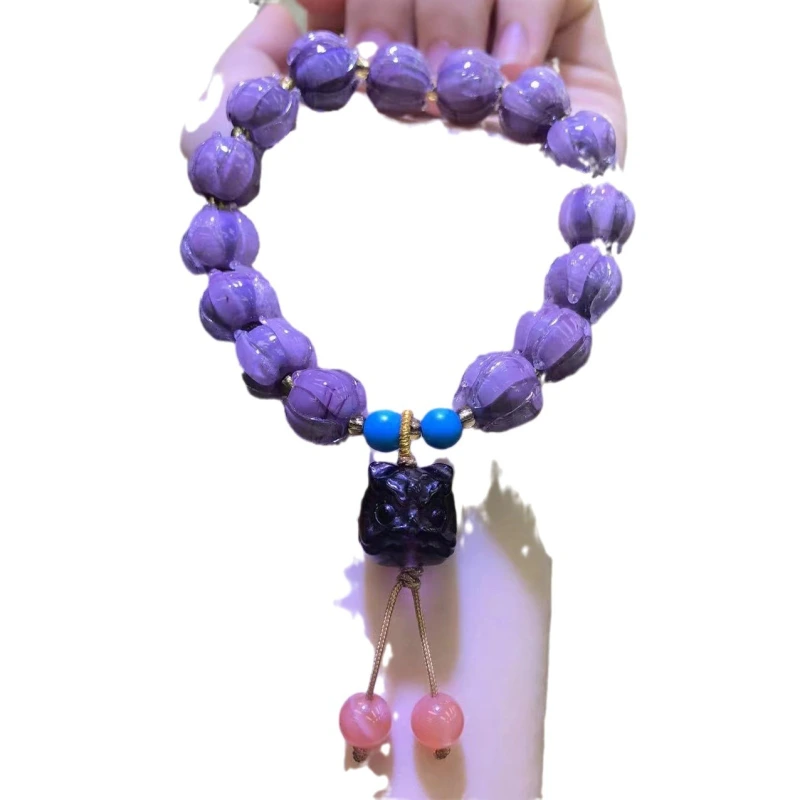 This purple glass bead bracelet comes from Chinese temples. It is believed to bring good luck, love and empower the wearer.