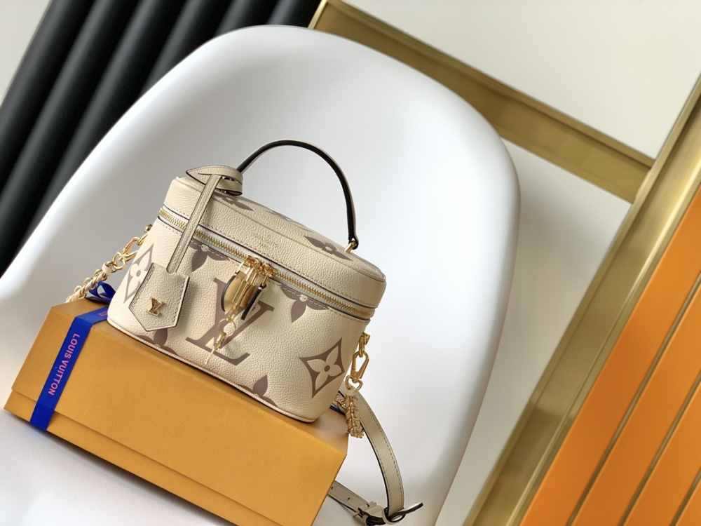 This Vanity Small Handbag Fusion  Giant Monogram embossing, an elegant shape and leather top handles.