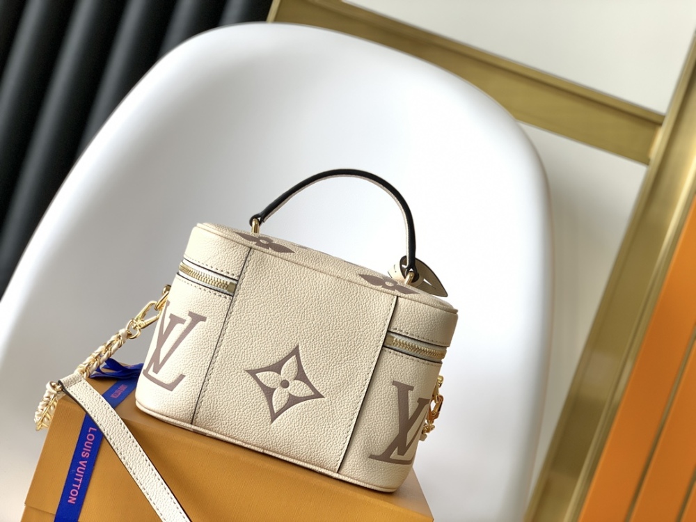 This Vanity Small Handbag Fusion  Giant Monogram embossing, an elegant shape and leather top handles.