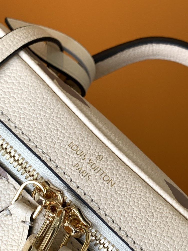 This Vanity Small Handbag Fusion  Giant Monogram embossing, an elegant shape and leather top handles.