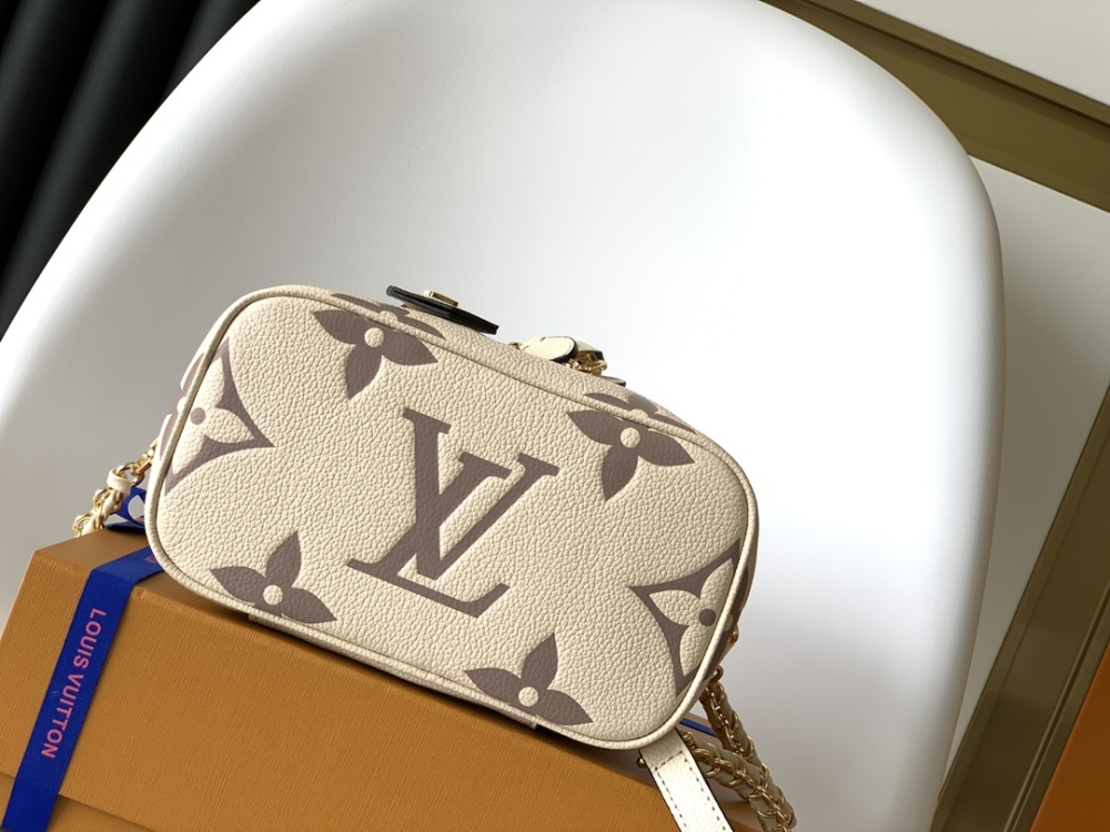 This Vanity Small Handbag Fusion  Giant Monogram embossing, an elegant shape and leather top handles.