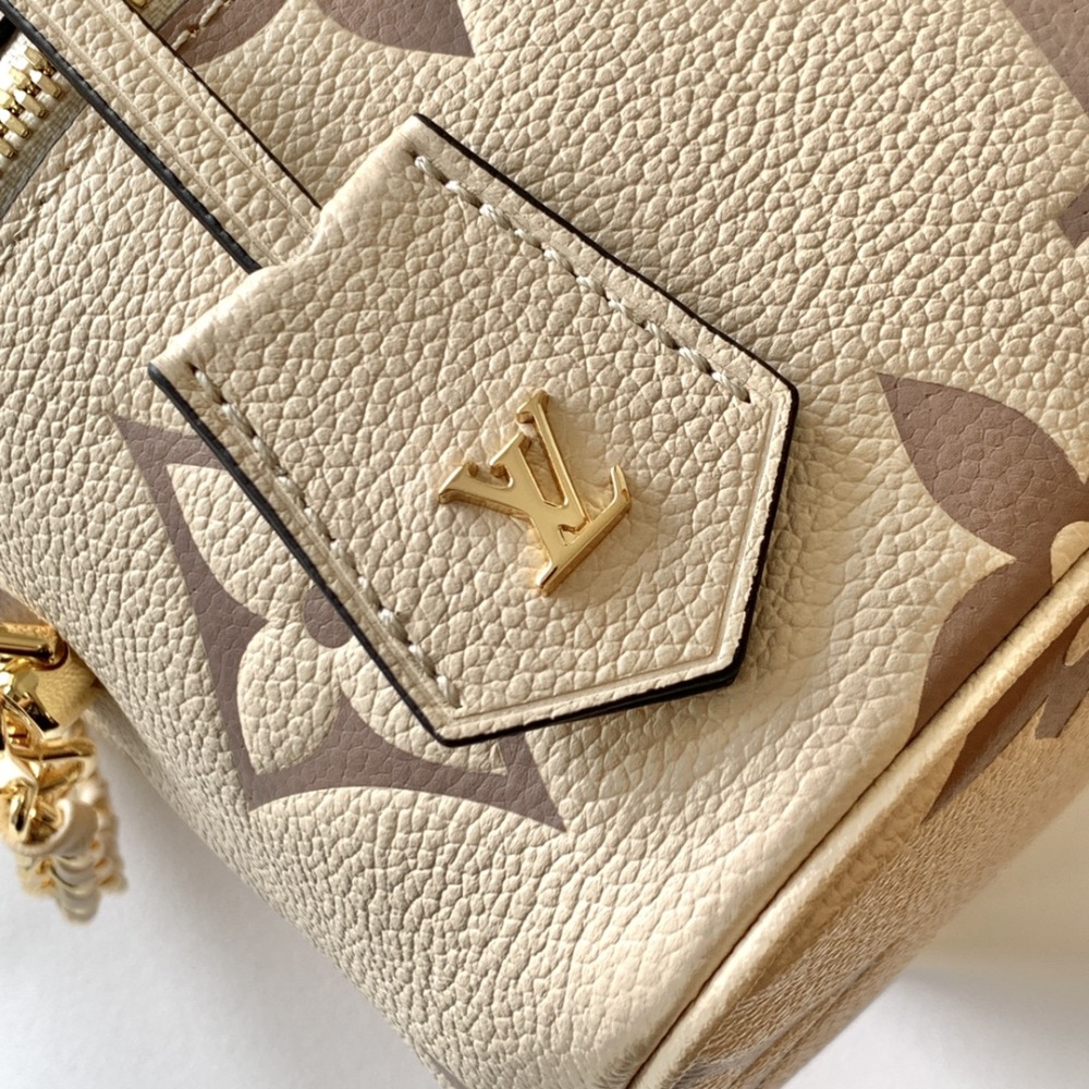 This Vanity Small Handbag Fusion  Giant Monogram embossing, an elegant shape and leather top handles.