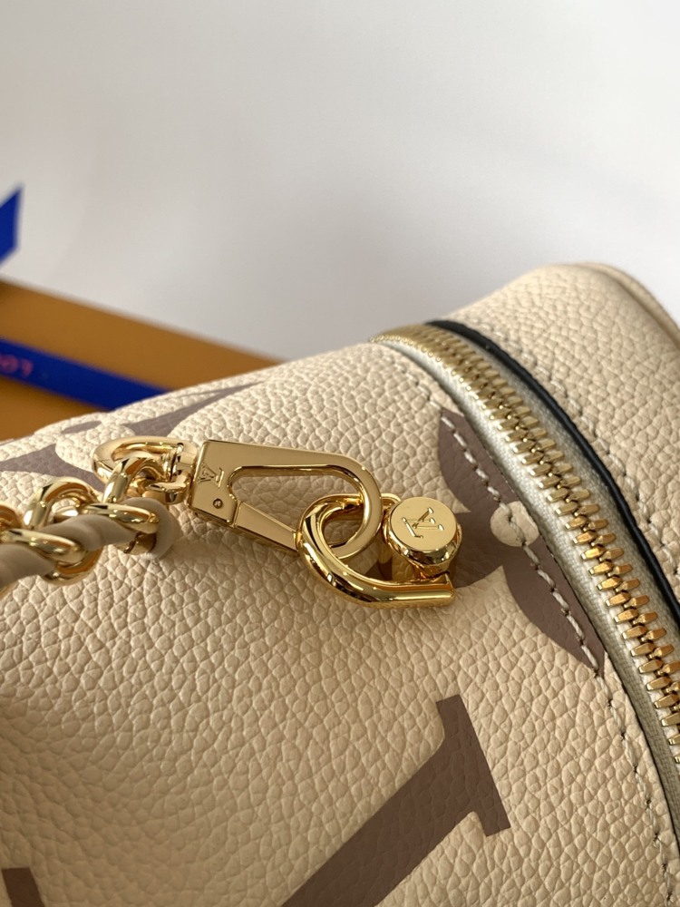 This Vanity Small Handbag Fusion  Giant Monogram embossing, an elegant shape and leather top handles.