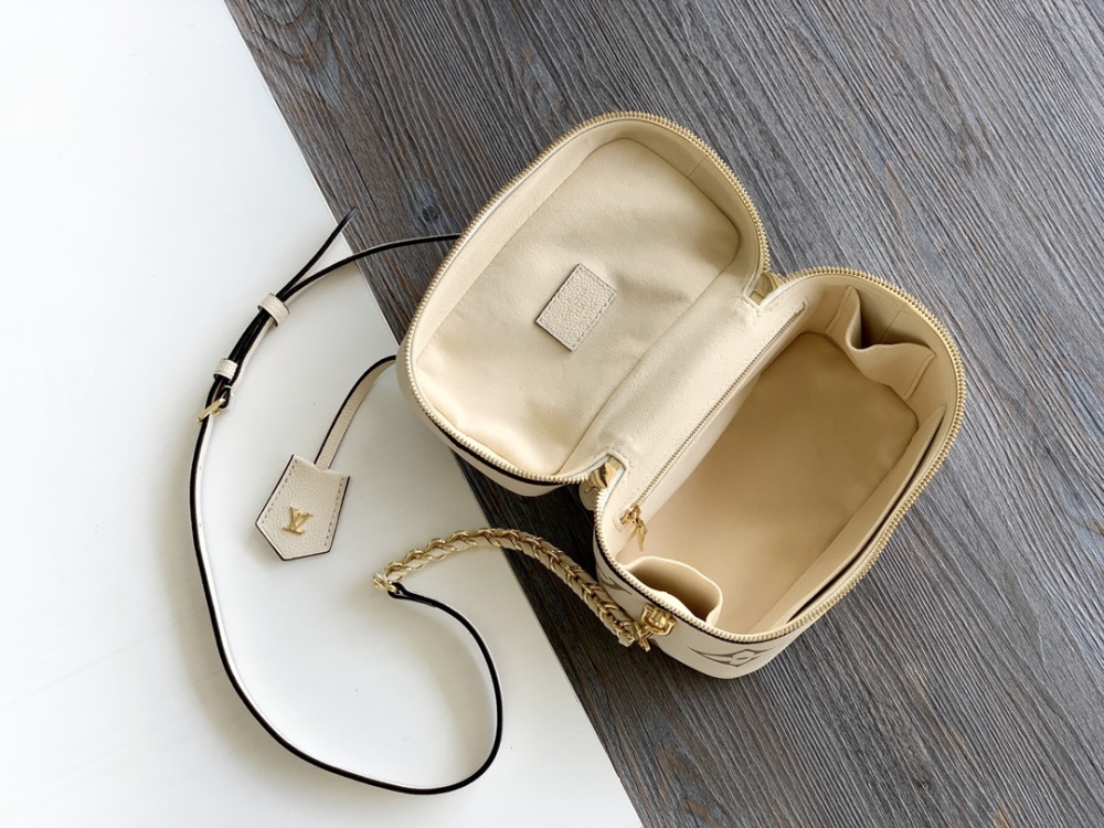 This Vanity Small Handbag Fusion  Giant Monogram embossing, an elegant shape and leather top handles.