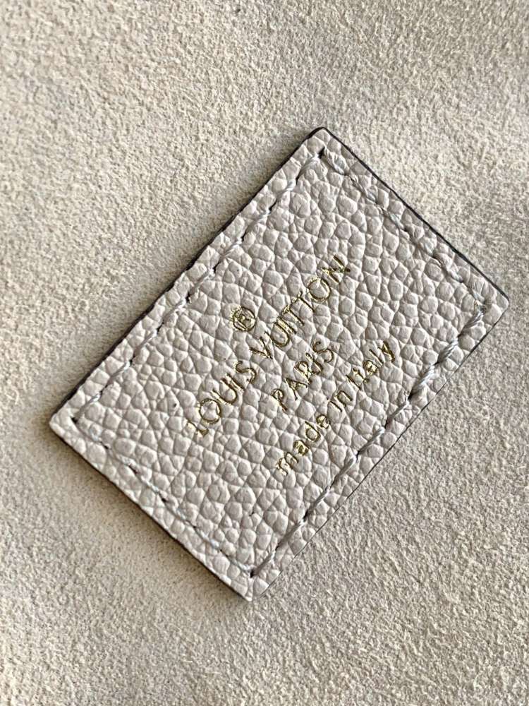 This Vanity Small Handbag Fusion  Giant Monogram embossing, an elegant shape and leather top handles.