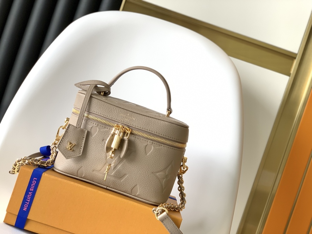 This Vanity Small Handbag Fusion  Giant Monogram embossing, an elegant shape and leather top handles.