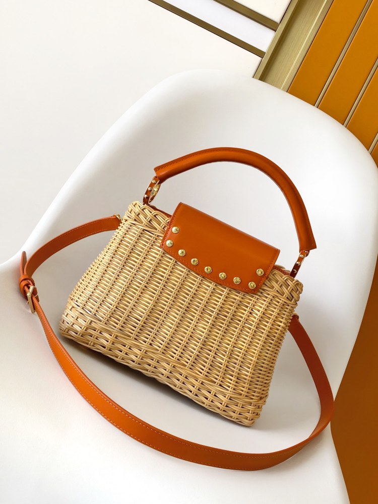The Capucines BB handbag is a chic composition of woven rattan in homage to the Louis Vuitton picnic case design of 1892.