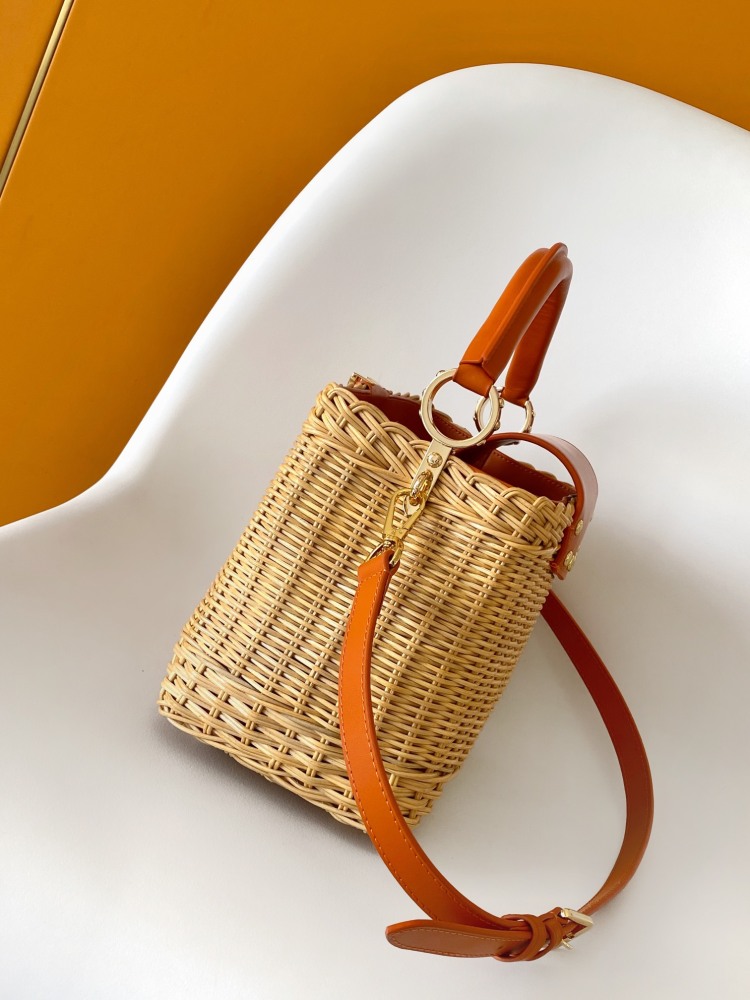 The Capucines BB handbag is a chic composition of woven rattan in homage to the Louis Vuitton picnic case design of 1892.