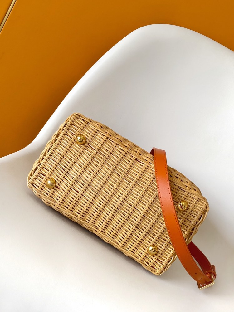 The Capucines BB handbag is a chic composition of woven rattan in homage to the Louis Vuitton picnic case design of 1892.