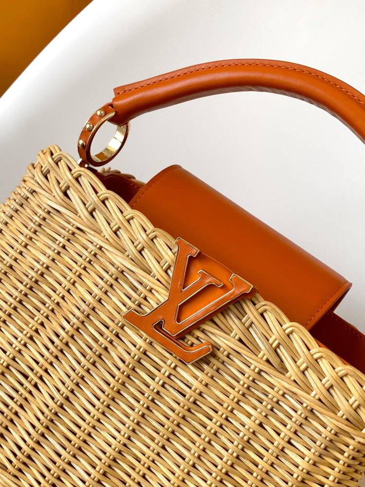 The Capucines BB handbag is a chic composition of woven rattan in homage to the Louis Vuitton picnic case design of 1892.