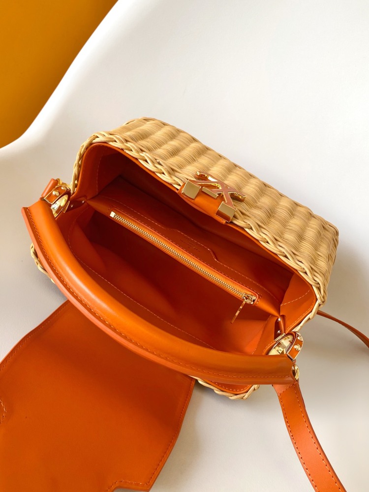 The Capucines BB handbag is a chic composition of woven rattan in homage to the Louis Vuitton picnic case design of 1892.