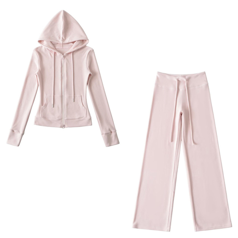 Relaxed fit red tracksuit with long-sleeved hooded zip-up jacket and loose drawstring wide-leg pants.