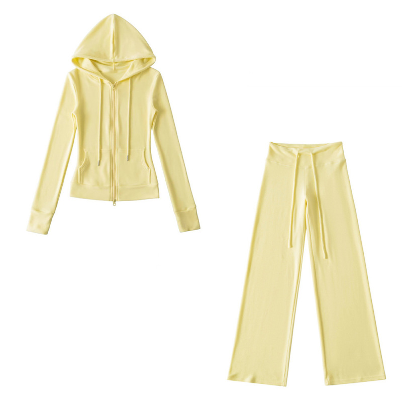Relaxed fit red tracksuit with long-sleeved hooded zip-up jacket and loose drawstring wide-leg pants.