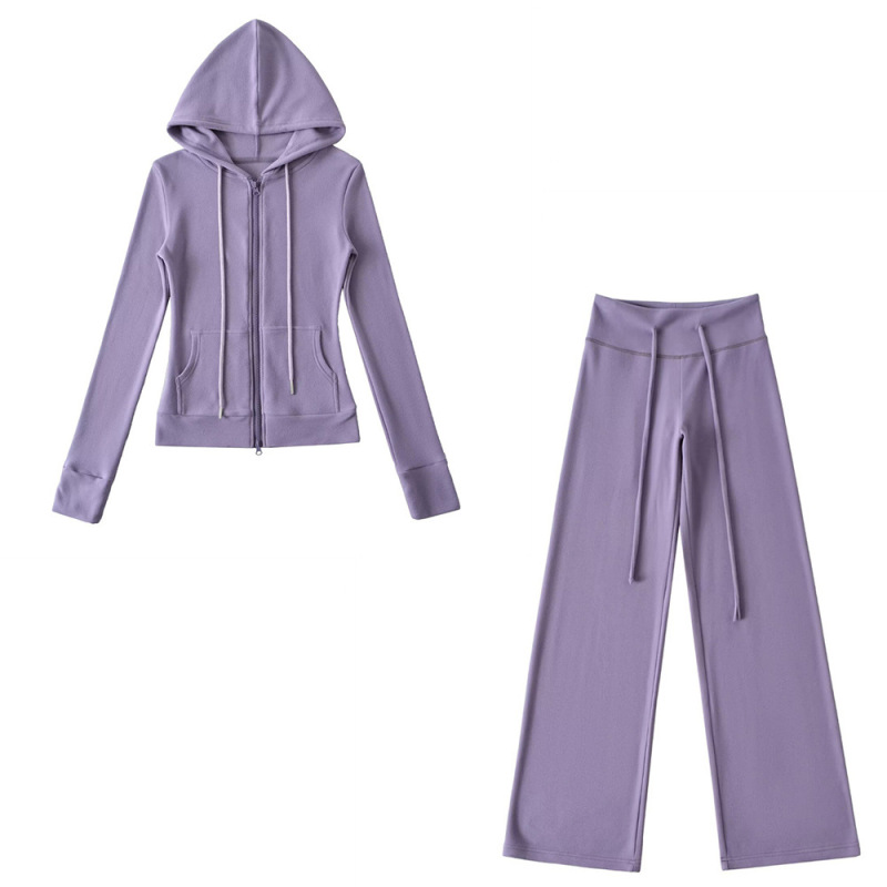 Relaxed fit red tracksuit with long-sleeved hooded zip-up jacket and loose drawstring wide-leg pants.