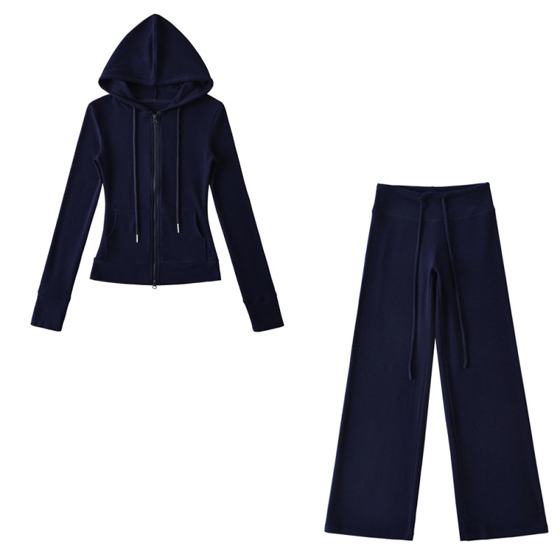 Relaxed fit red tracksuit with long-sleeved hooded zip-up jacket and loose drawstring wide-leg pants.