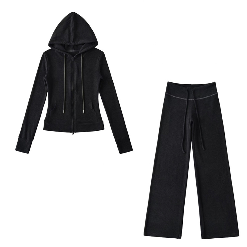 Relaxed fit red tracksuit with long-sleeved hooded zip-up jacket and loose drawstring wide-leg pants.
