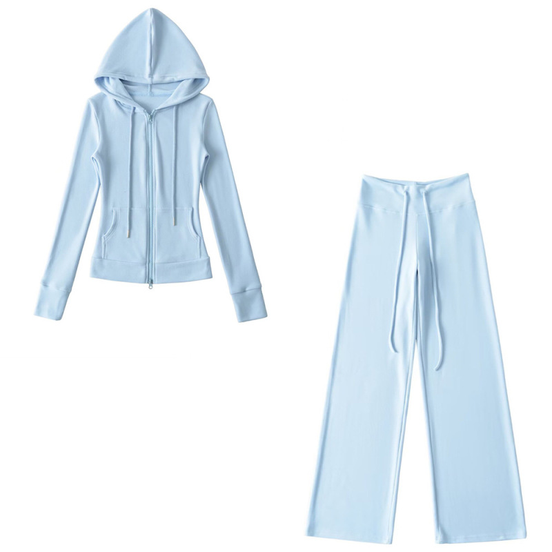 Relaxed fit red tracksuit with long-sleeved hooded zip-up jacket and loose drawstring wide-leg pants.