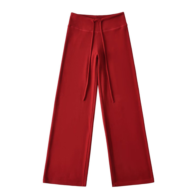 Relaxed fit red tracksuit with long-sleeved hooded zip-up jacket and loose drawstring wide-leg pants.