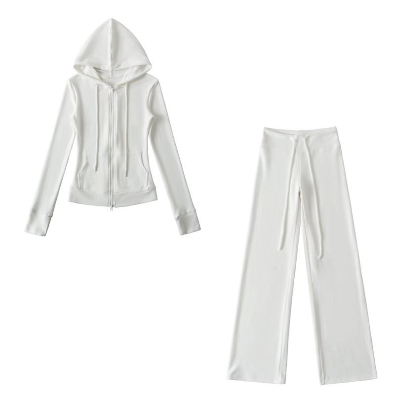 Relaxed fit red tracksuit with long-sleeved hooded zip-up jacket and loose drawstring wide-leg pants.