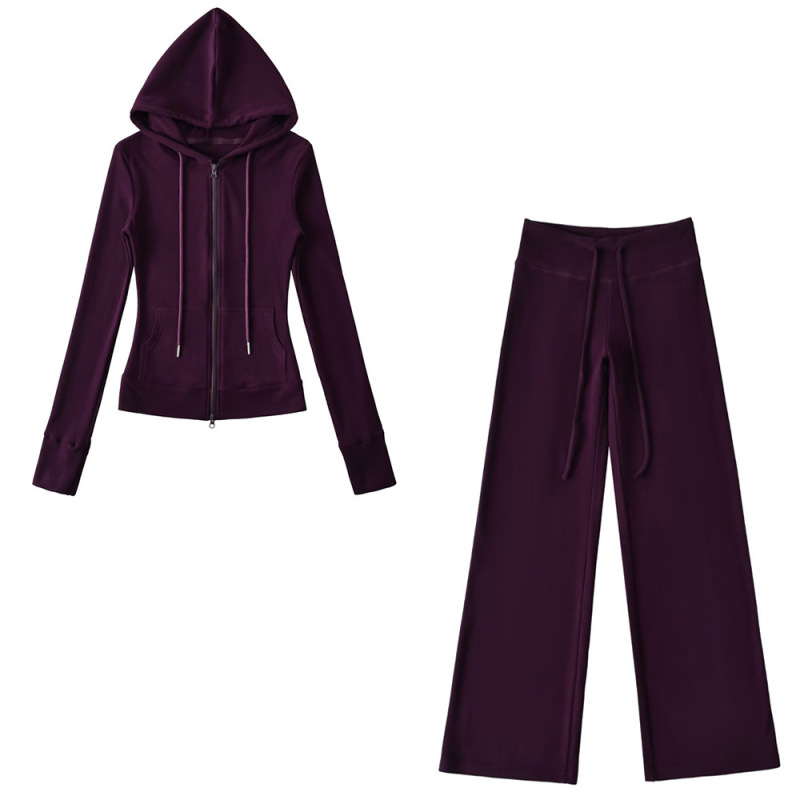 Relaxed fit red tracksuit with long-sleeved hooded zip-up jacket and loose drawstring wide-leg pants.