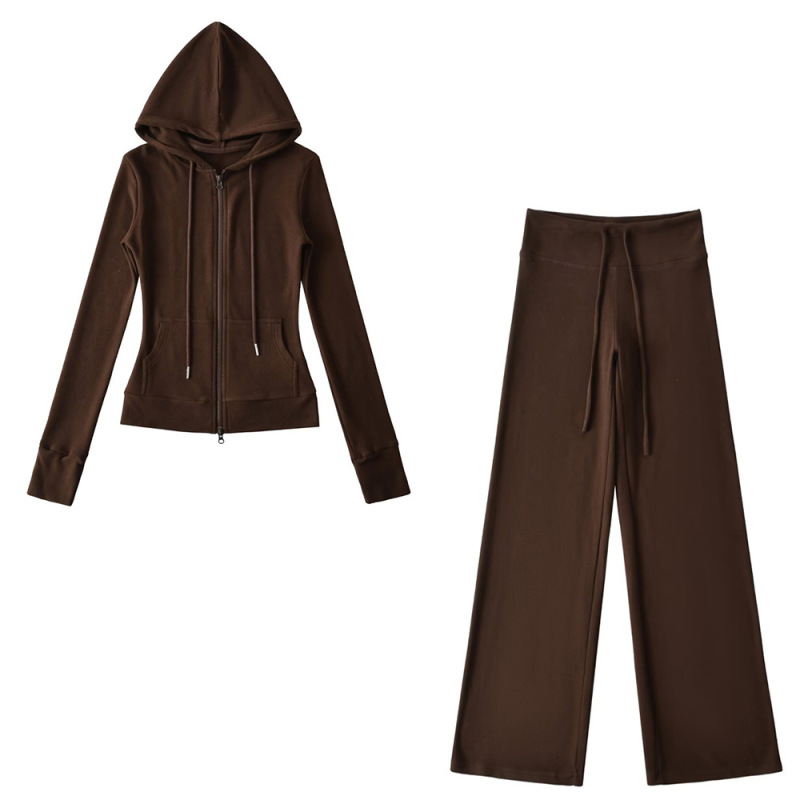 Relaxed fit red tracksuit with long-sleeved hooded zip-up jacket and loose drawstring wide-leg pants.