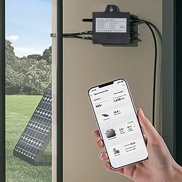 Solar power system with wall-mounted control box, smartphone displaying energy data, and solar panel visible through window. Hand holds phone showing power generation statistics.