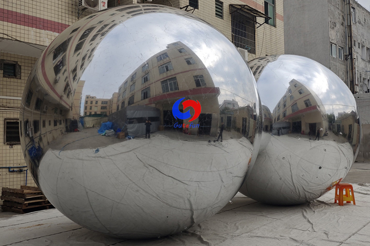 Corporate events backdrop giant balloons hanging big shiny silver inflatable sphere mirror balls as decoration