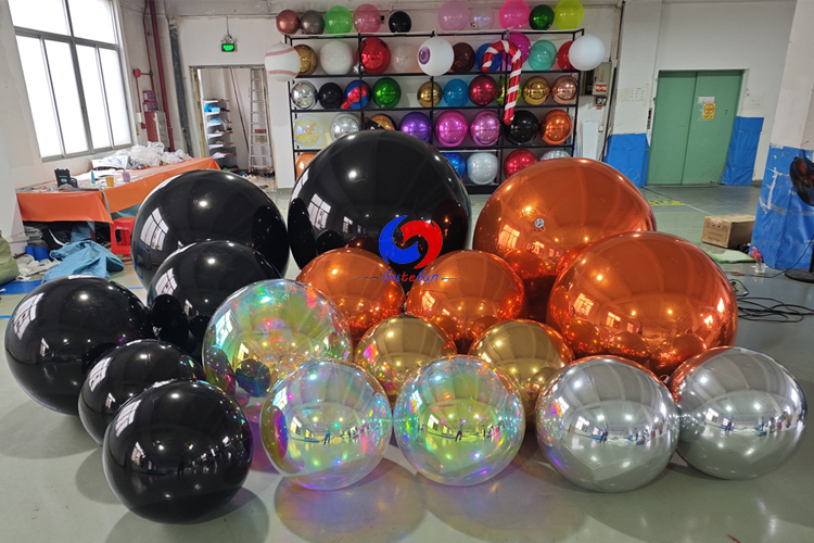 giant black shiny spheres giant orange silver gold iridescent shiny ballons