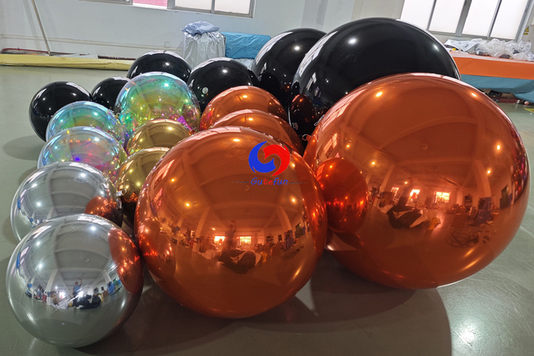 giant black shiny spheres giant orange silver gold iridescent shiny ballons