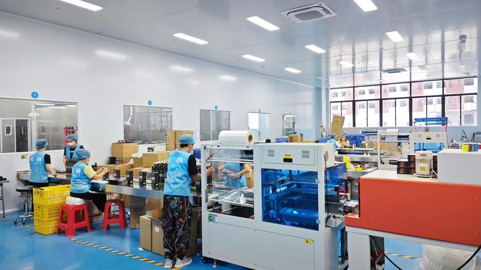 Workers on the hair color packing and shrink-wrap line at Mingli's cleanroom facility