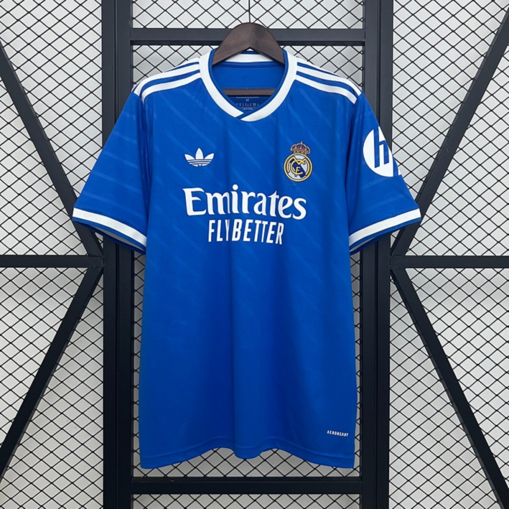 2025-26 Real Madrid second away jersey fan version short-sleeve in royal blue with white details, featuring Emirates Fly Better sponsor logo and Adidas stripes.
