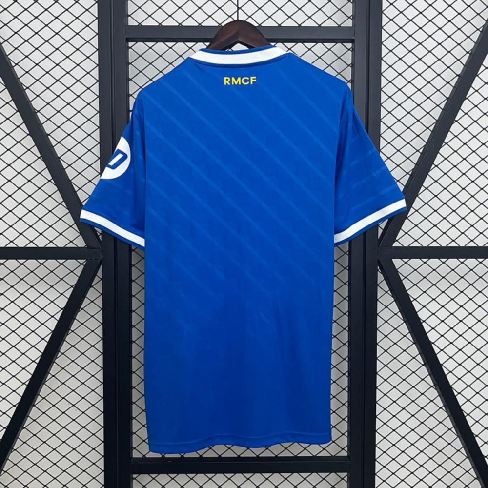 Back view of 2025-26 Real Madrid second away jersey fan version in blue, featuring yellow RMCF text at the top.