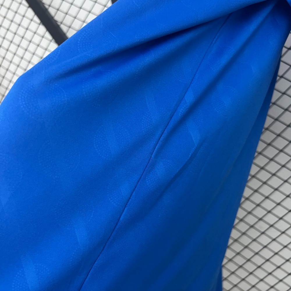Close-up texture of the 2025-26 Real Madrid second away fan version jersey, showing blue fabric pattern and fine stitching detail.