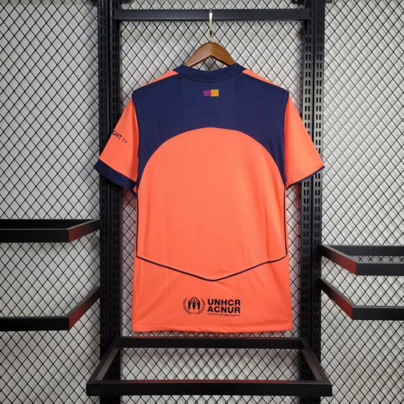 Back view of the 2025-26 FC Barcelona Second Away Jersey in orange and navy, featuring UNHCR ACNUR logo and Catalan flag graphic under the collar.