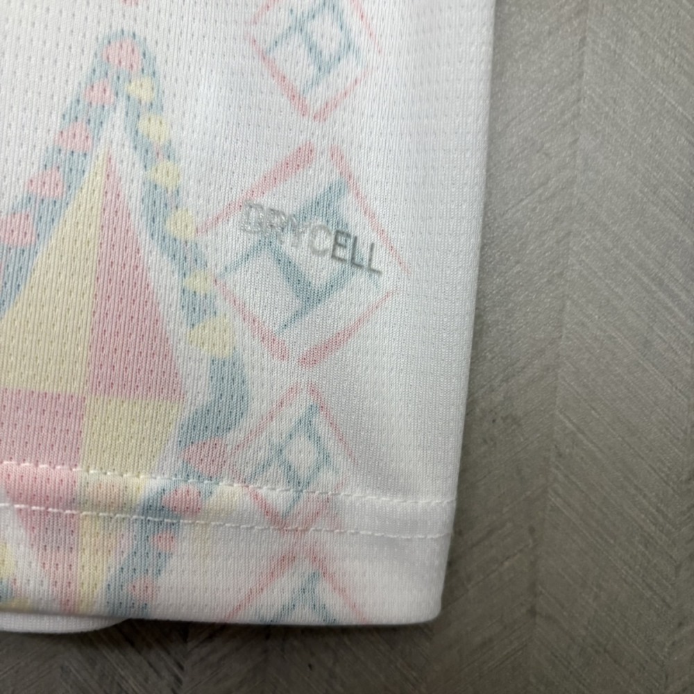 Fabric close-up showing breathable mesh material and African geometric pattern on Senegal home jersey