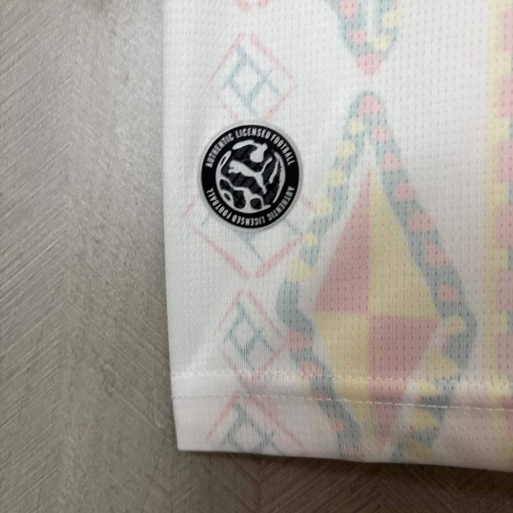 Detail of official licensed Puma authenticity badge on lower hem of Senegal home jersey