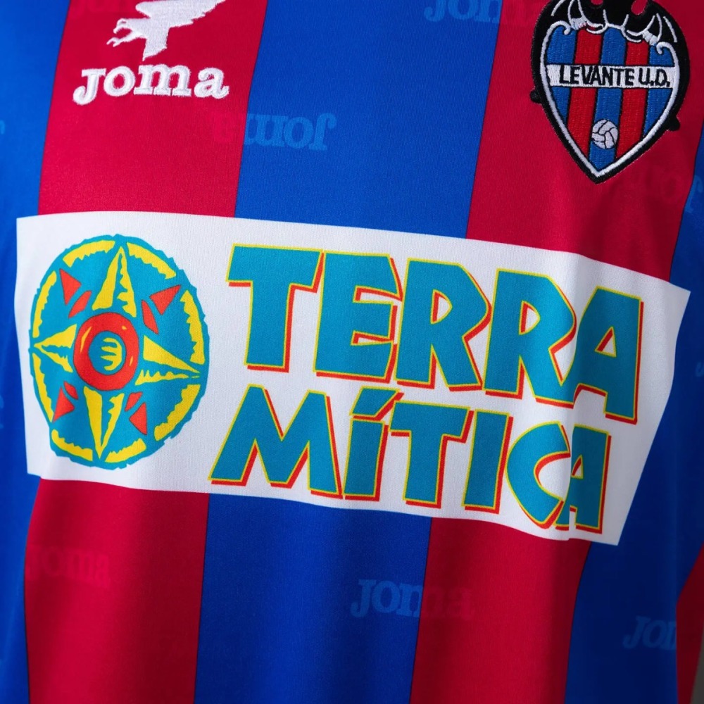The sponsor panel on the Levante 1999-00 shirt - a white rectangle carrying a two-line teal wordmark outlined in a warm colour, with a roundel to its left showing a compass rose in turquoise and yellow with a red centre, set across the striped body