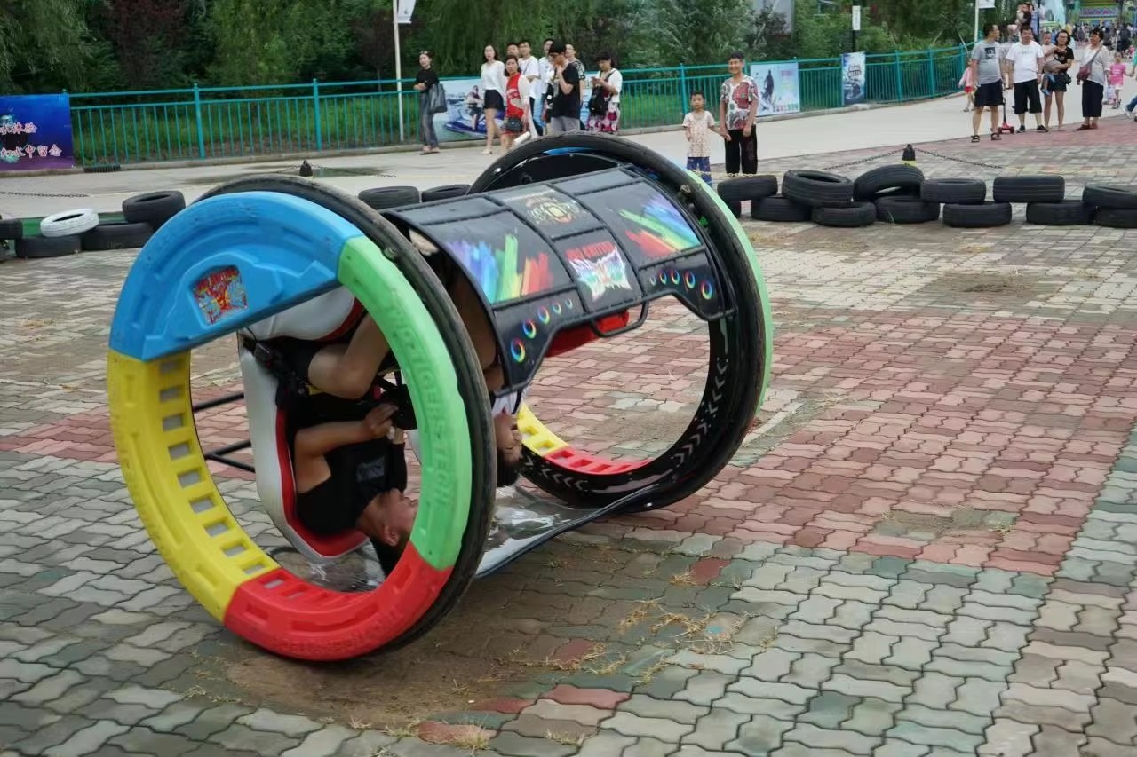 360 rolling car with full safety harness in motion at amusement park